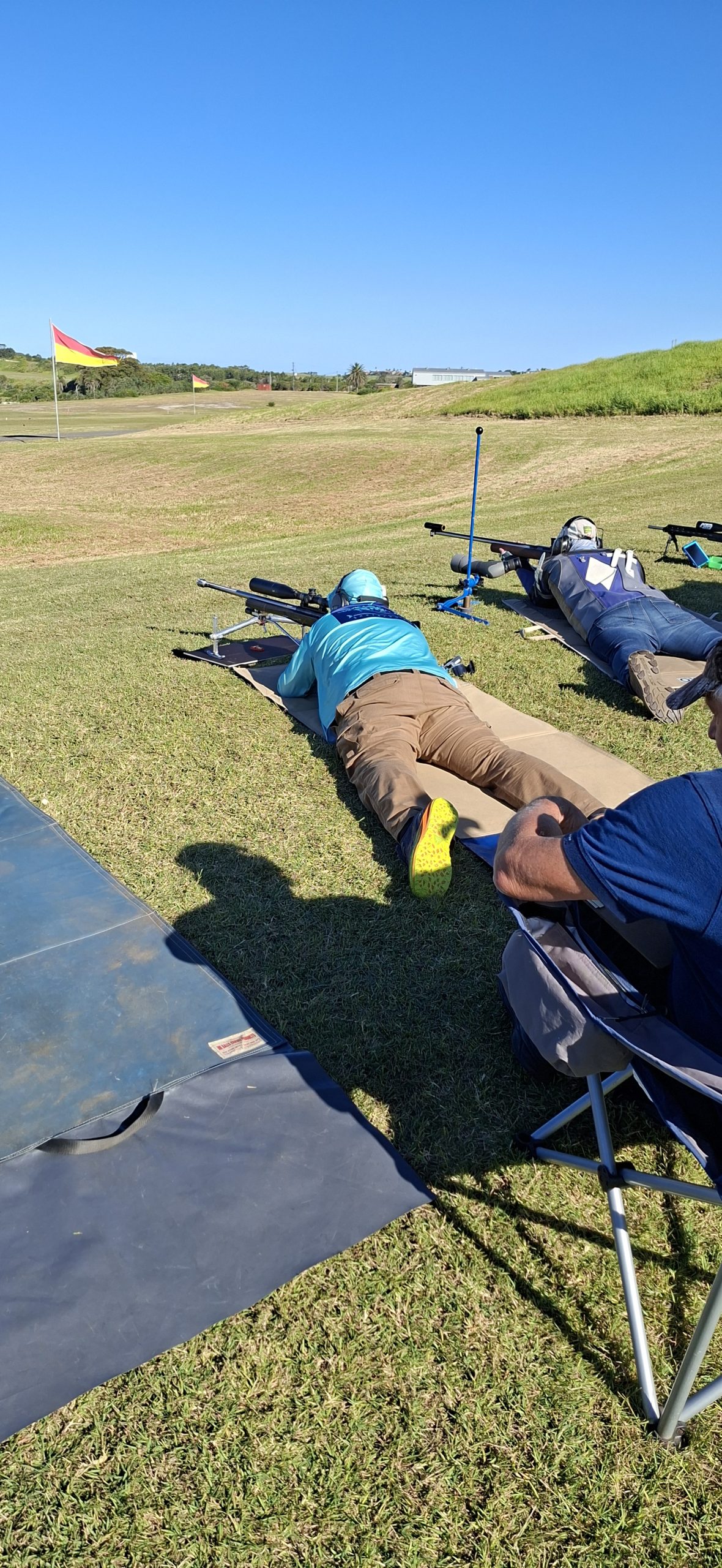 Members on the firing line under the range flag